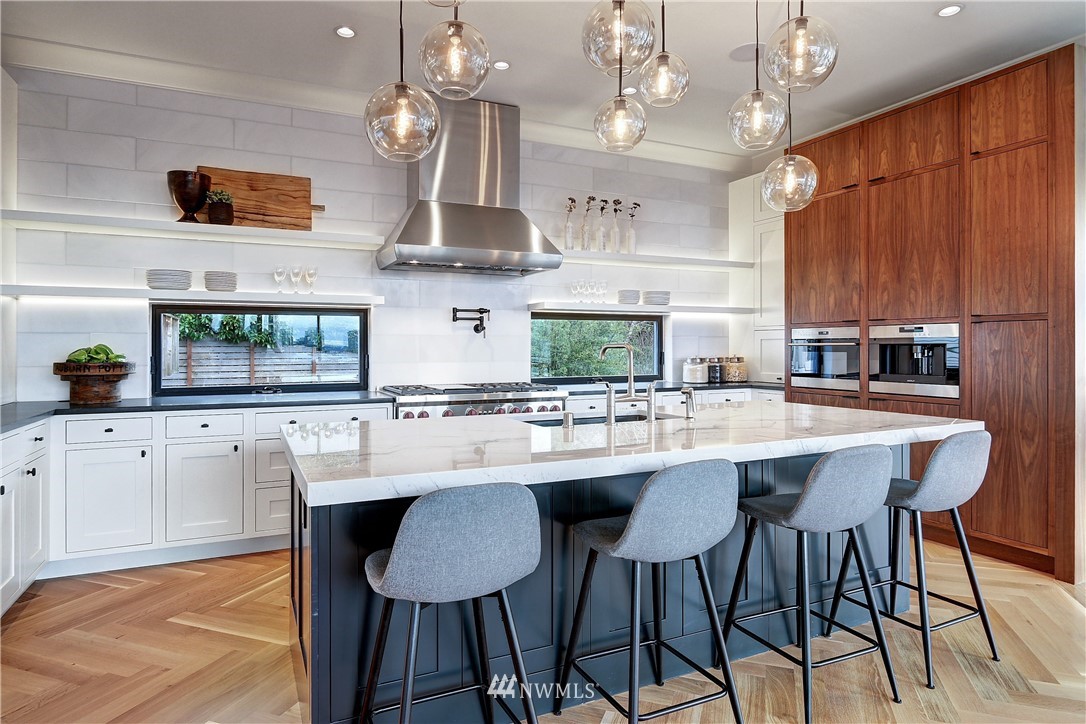 362 Ward Street Seattle, WA 98109 - Photo 8 of 40 a kitchen with stainless steel appliances kitchen island a table and chairs in it