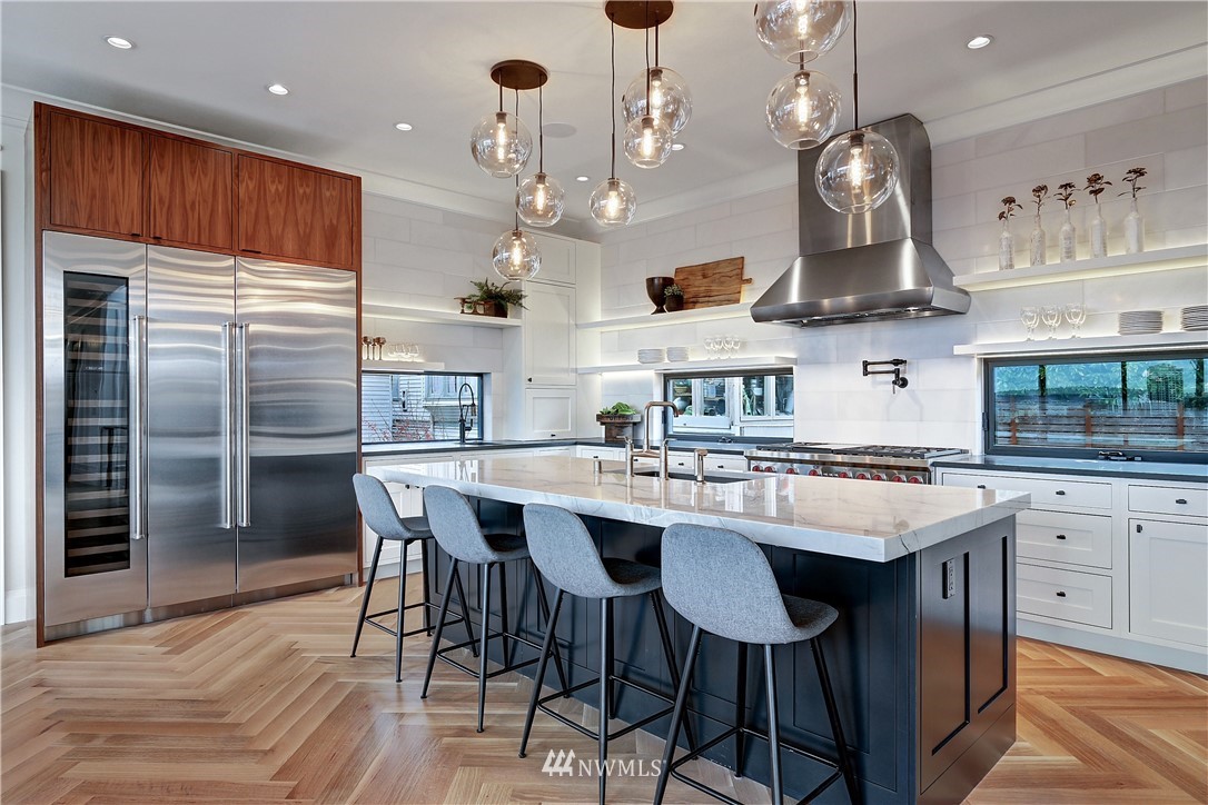 362 Ward Street Seattle, WA 98109 - Photo 10 of 40 a kitchen with stainless steel appliances granite countertop a sink stove and refrigerator