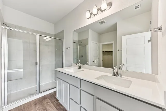 a bathroom with a double vanity sink mirror and double