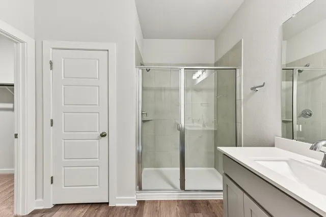 a bathroom with a shower and a sink
