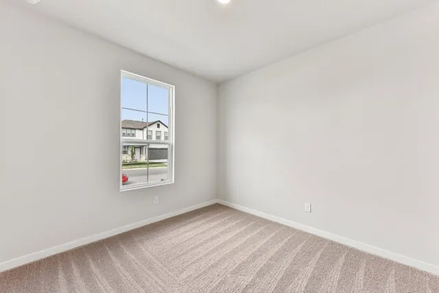 a view of an empty room and a window