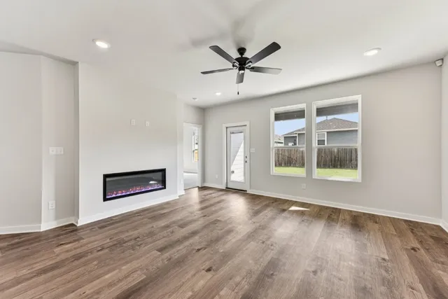 a view of wooden floor fire place and entryway in a room