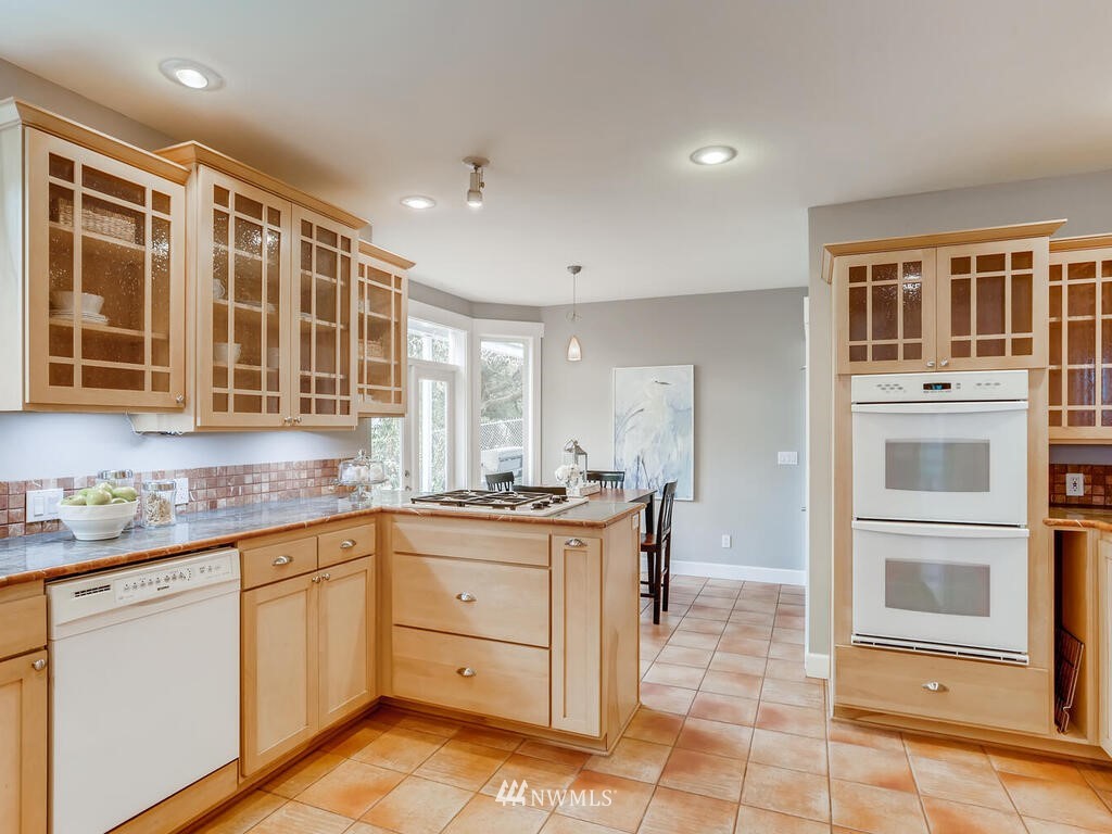 910 North 32nd Street Renton, WA 98056 - Photo 11 of 29 a kitchen with a sink stove and cabinets