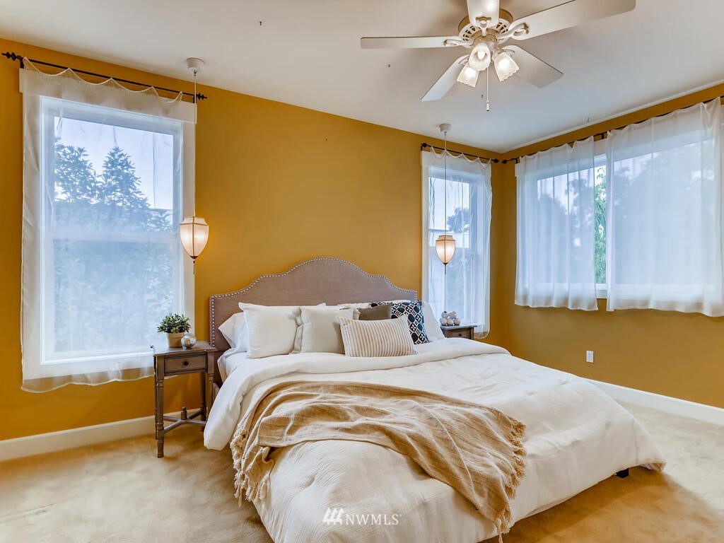 910 North 32nd Street Renton, WA 98056 - Photo 17 of 29 a bedroom with a bed and a chandelier