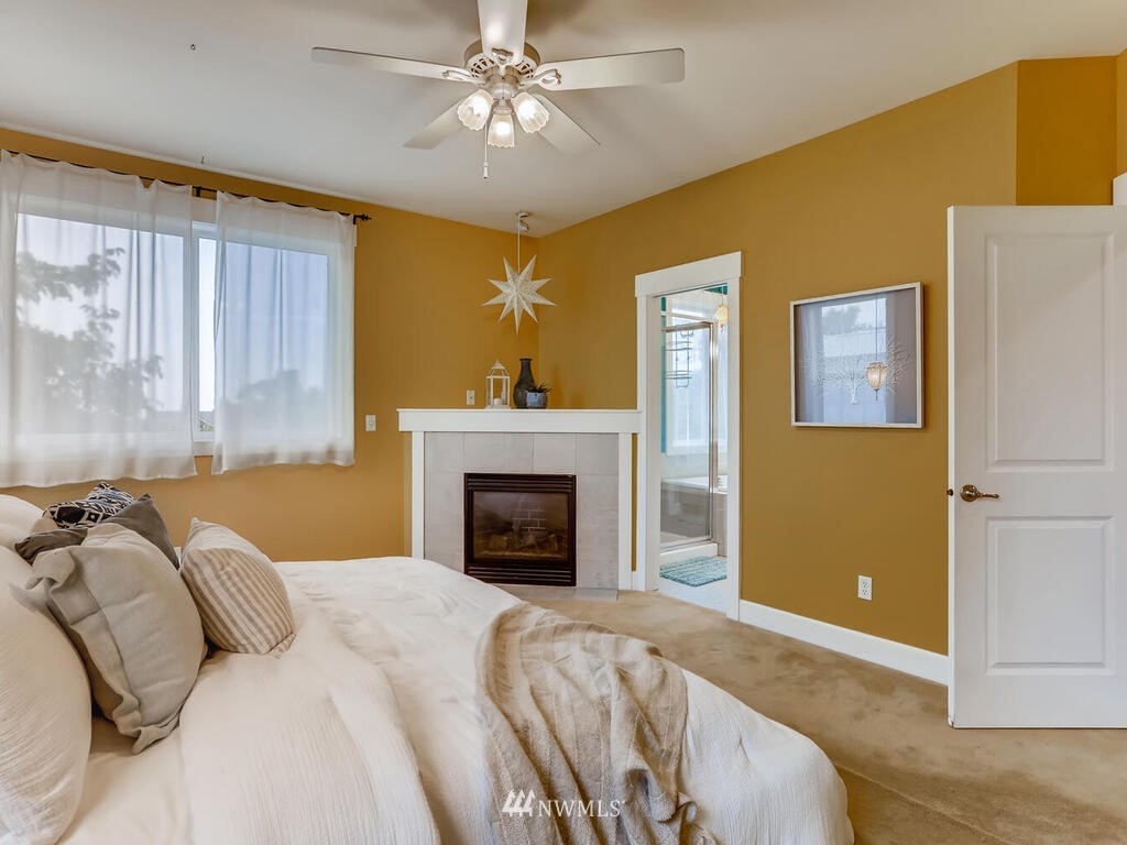 910 North 32nd Street Renton, WA 98056 - Photo 18 of 29 a bedroom with a bed and a fireplace