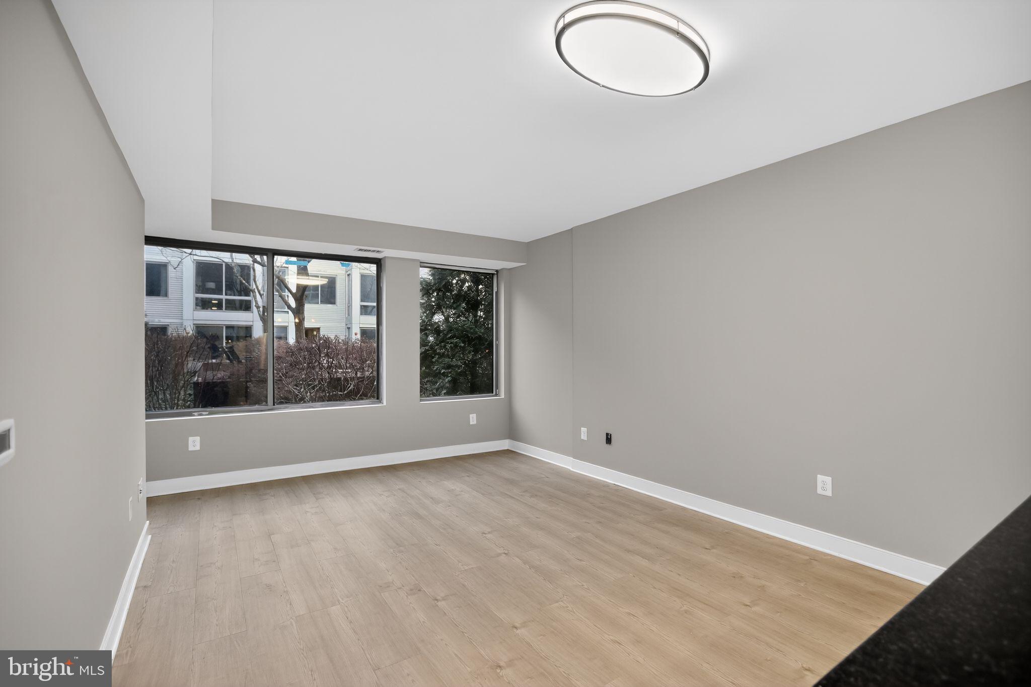 4101 Albemarle Street Northwest, Unit 317 Washington, DC 20016 - Photo 15 of 32 wooden floor in an empty room with a window