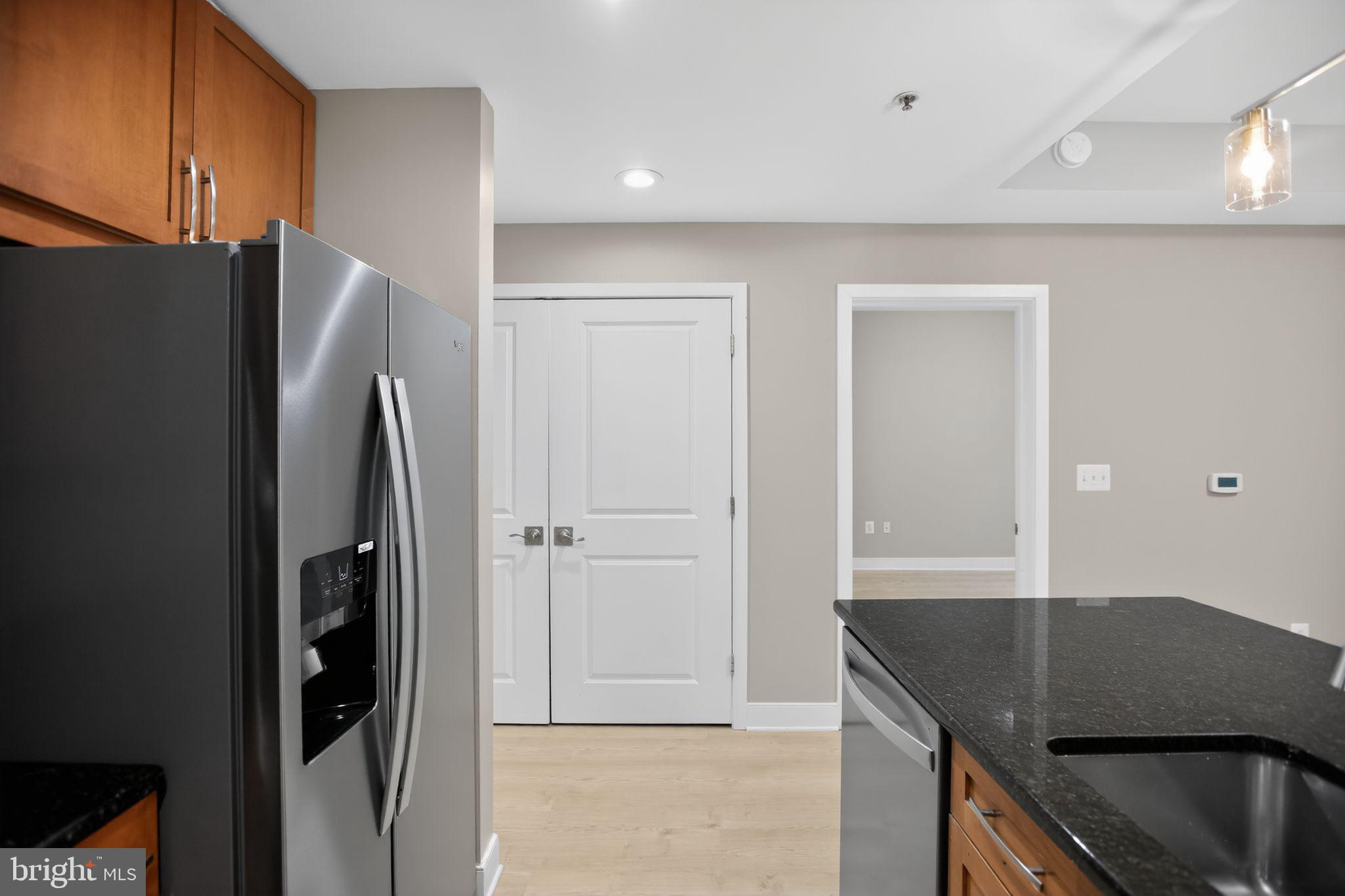 4101 Albemarle Street Northwest, Unit 317 Washington, DC 20016 - Photo 20 of 32 a kitchen with stainless steel appliances granite countertop a refrigerator and a stove top oven
