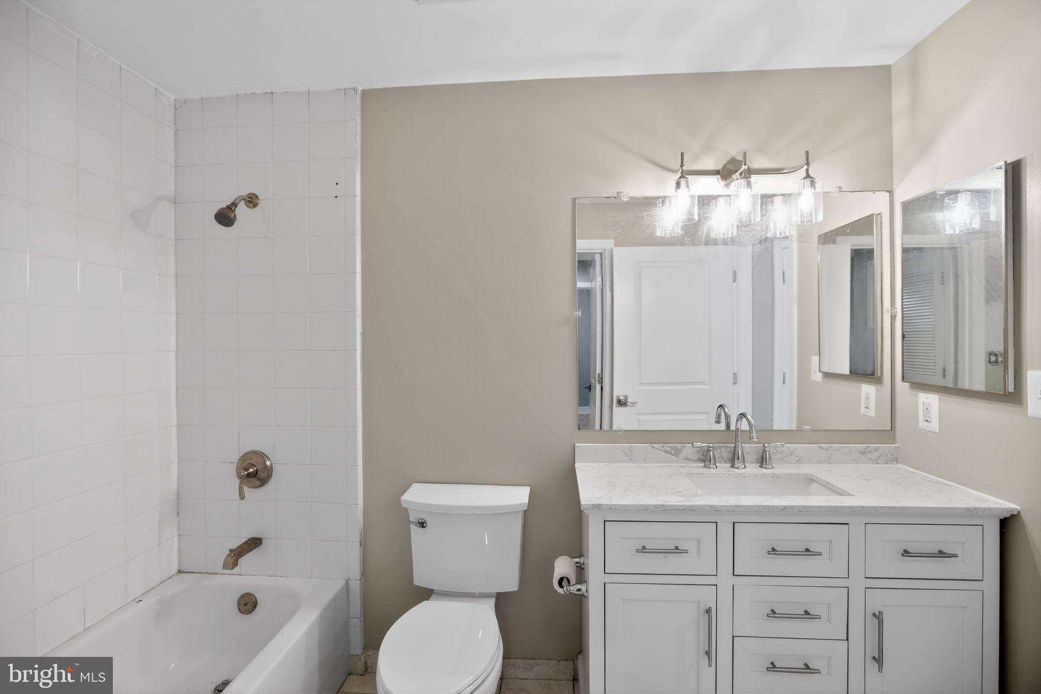 4101 Albemarle Street Northwest, Unit 317 Washington, DC 20016 - Photo 27 of 32 a bathroom with a toilet a sink and a bathtub