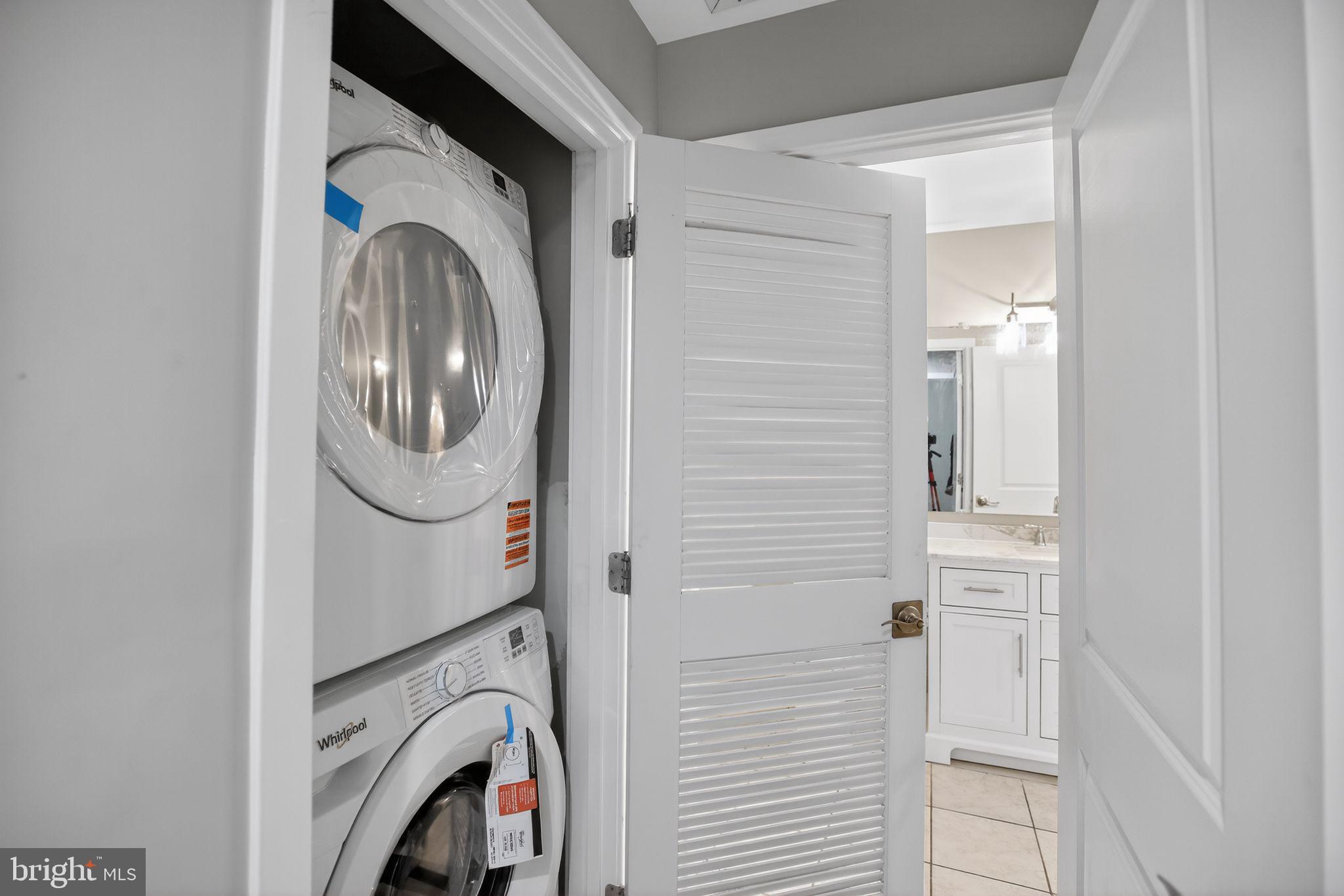 4101 Albemarle Street Northwest, Unit 317 Washington, DC 20016 - Photo 28 of 32 a utility room with dryer and washer