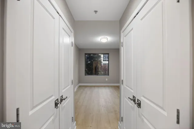 a view of a hallway with wooden shelves