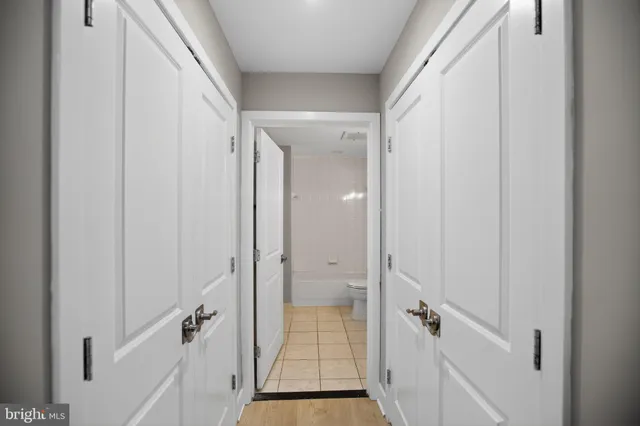 a view of a hallway with wooden floor