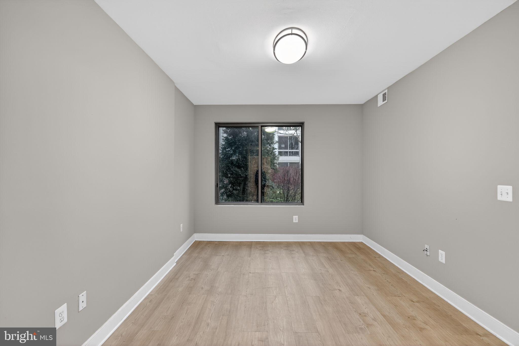 4101 Albemarle Street Northwest, Unit 317 Washington, DC 20016 - Photo 3 of 32 wooden floor in an empty room with a window