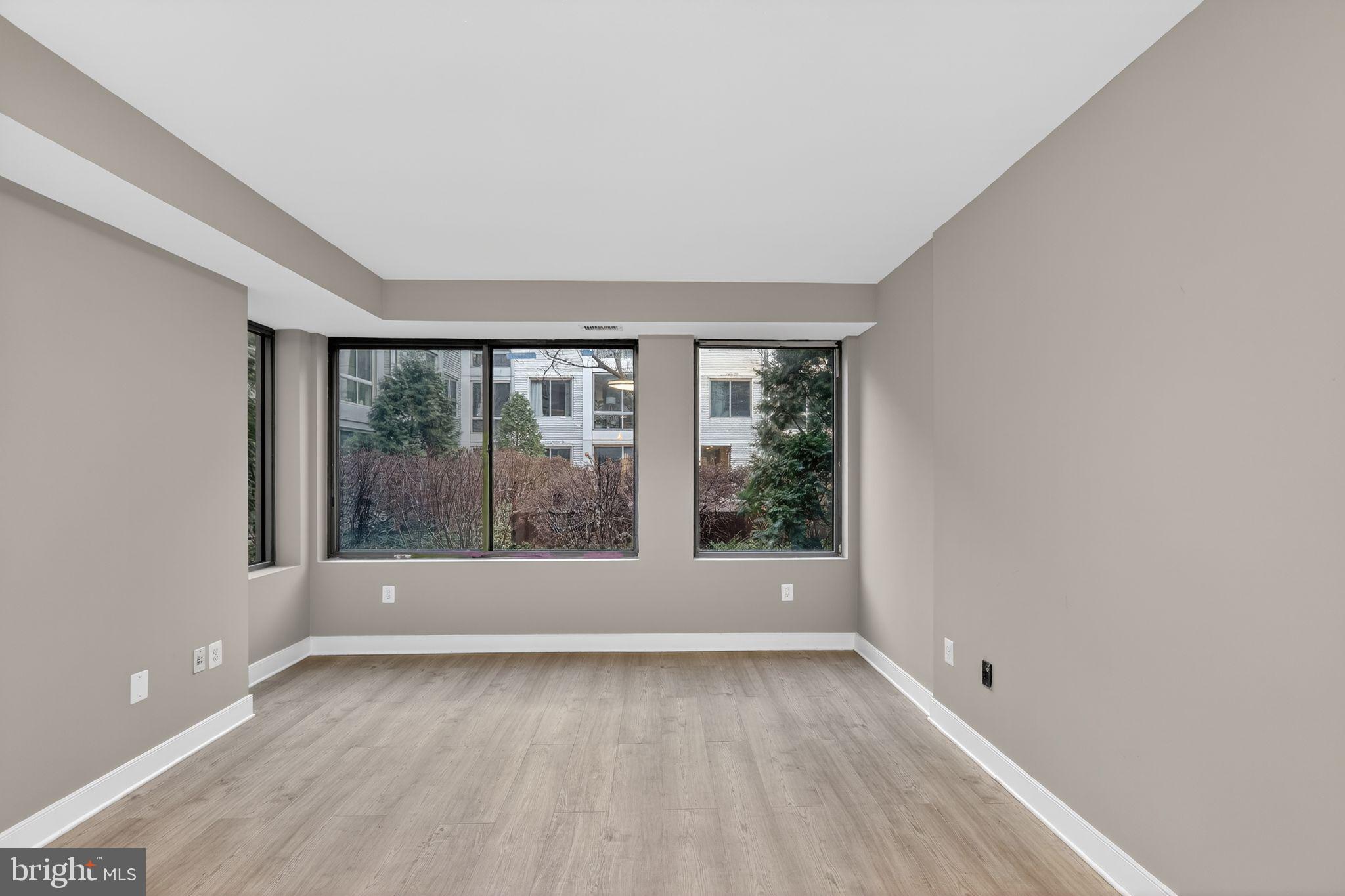 4101 Albemarle Street Northwest, Unit 317 Washington, DC 20016 - Photo 4 of 32 a view of wooden floor and window in a room