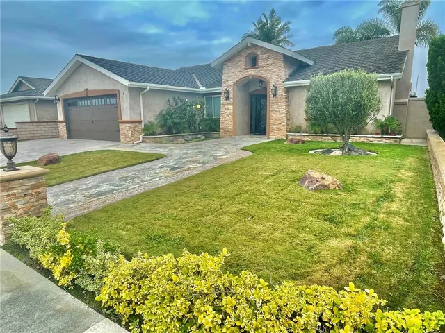 a front view of a house with garden