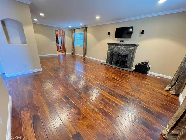a view of a livingroom with an empty space and a fireplace