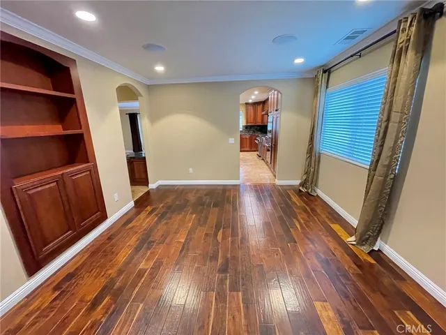 a view of a hallway with wooden floor and stairs