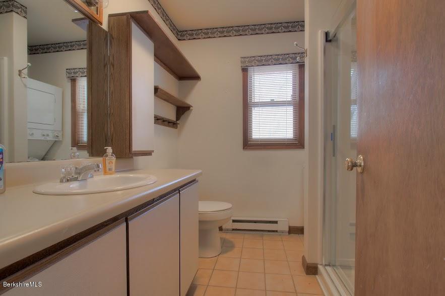 27 A Birch Road Copake, NY 12516 - Photo 14 of 16 a bathroom with a sink a toilet and a mirror