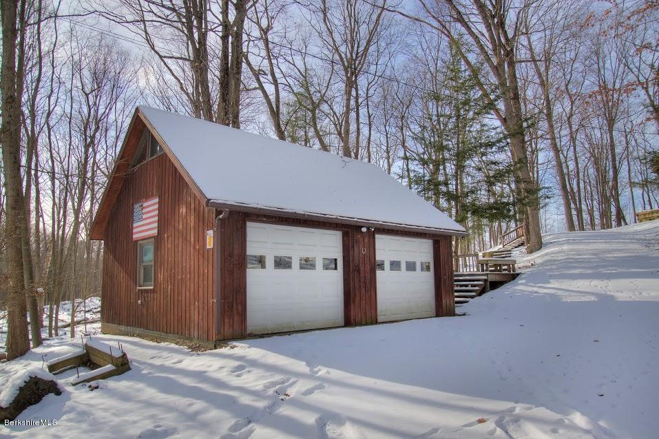 27 A Birch Road Copake, NY 12516 - Photo 4 of 16 a front view of a house with a yard and garage