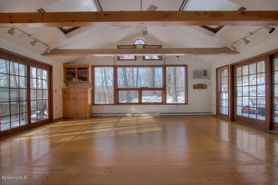 27 A Birch Road Copake, NY 12516 - Photo 5 of 16 an empty room with wooden floor and windows