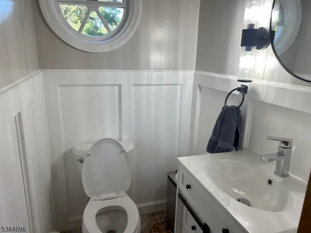 a bathroom with a sink toilet and a mirror