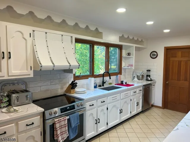 a kitchen that has a sink and a stove