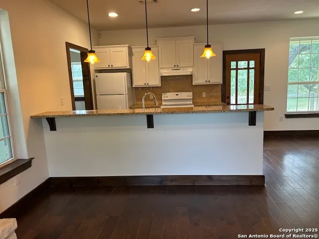 a kitchen with stainless steel appliances a refrigerator sink and stove