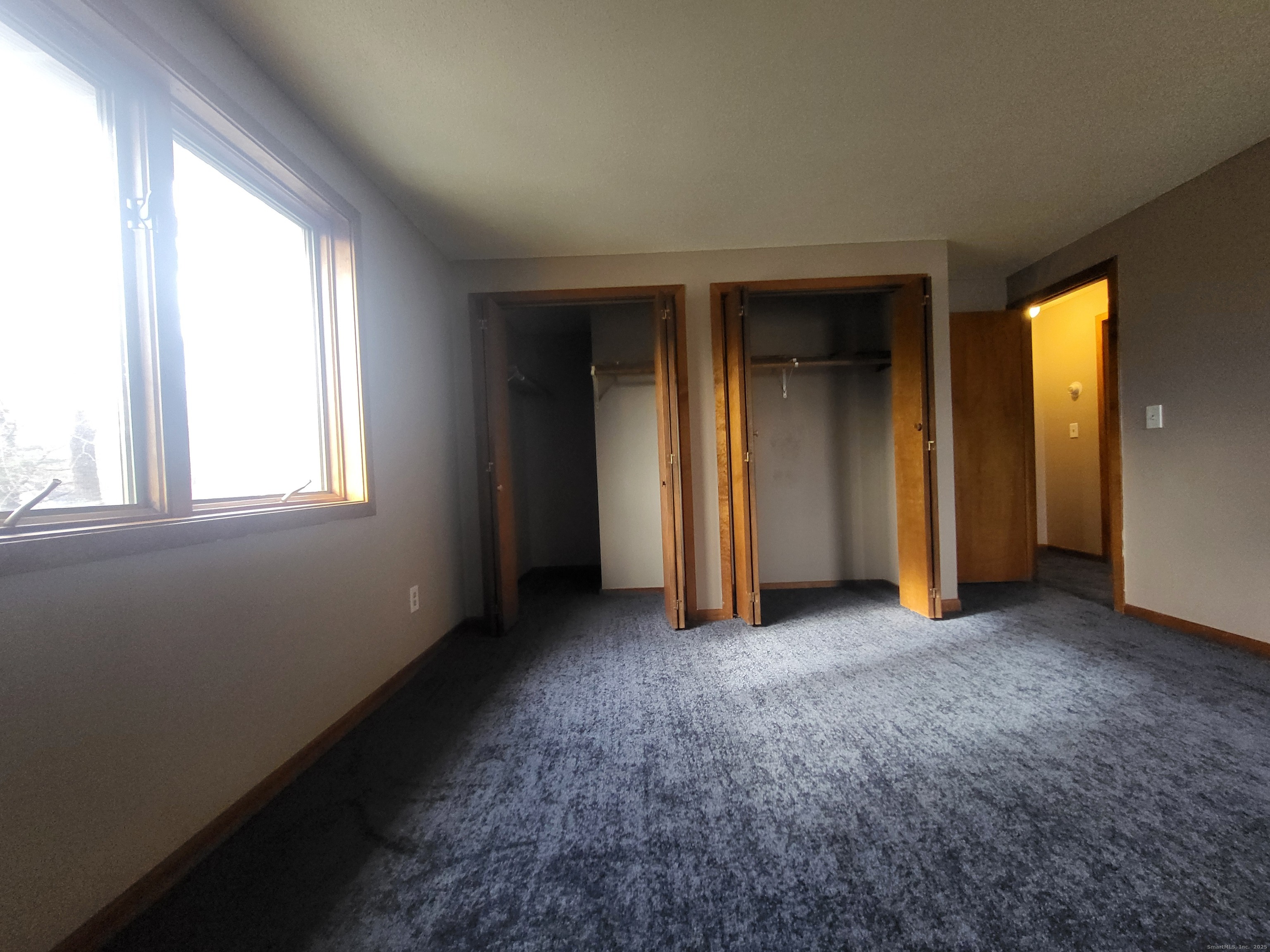 1730 Farmington Avenue, Unit A Farmington, CT 06085 - Photo 5 of 10 an empty room with windows and closet