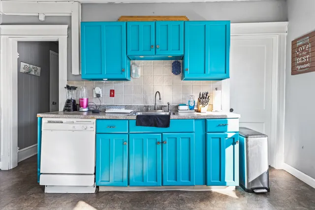 a kitchen with granite countertop wooden cabinets and white appliances