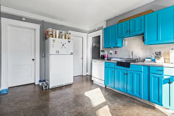 a kitchen with refrigerator and cabinets