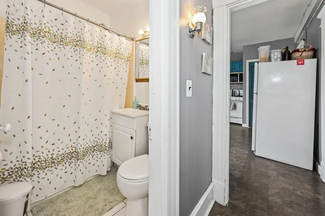 a bathroom with a toilet and a shower