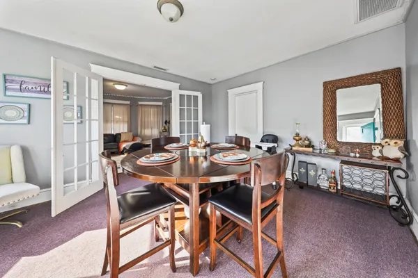 a view of a dining room with furniture and window