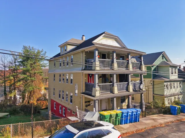 a front view of a residential apartment building with a yard