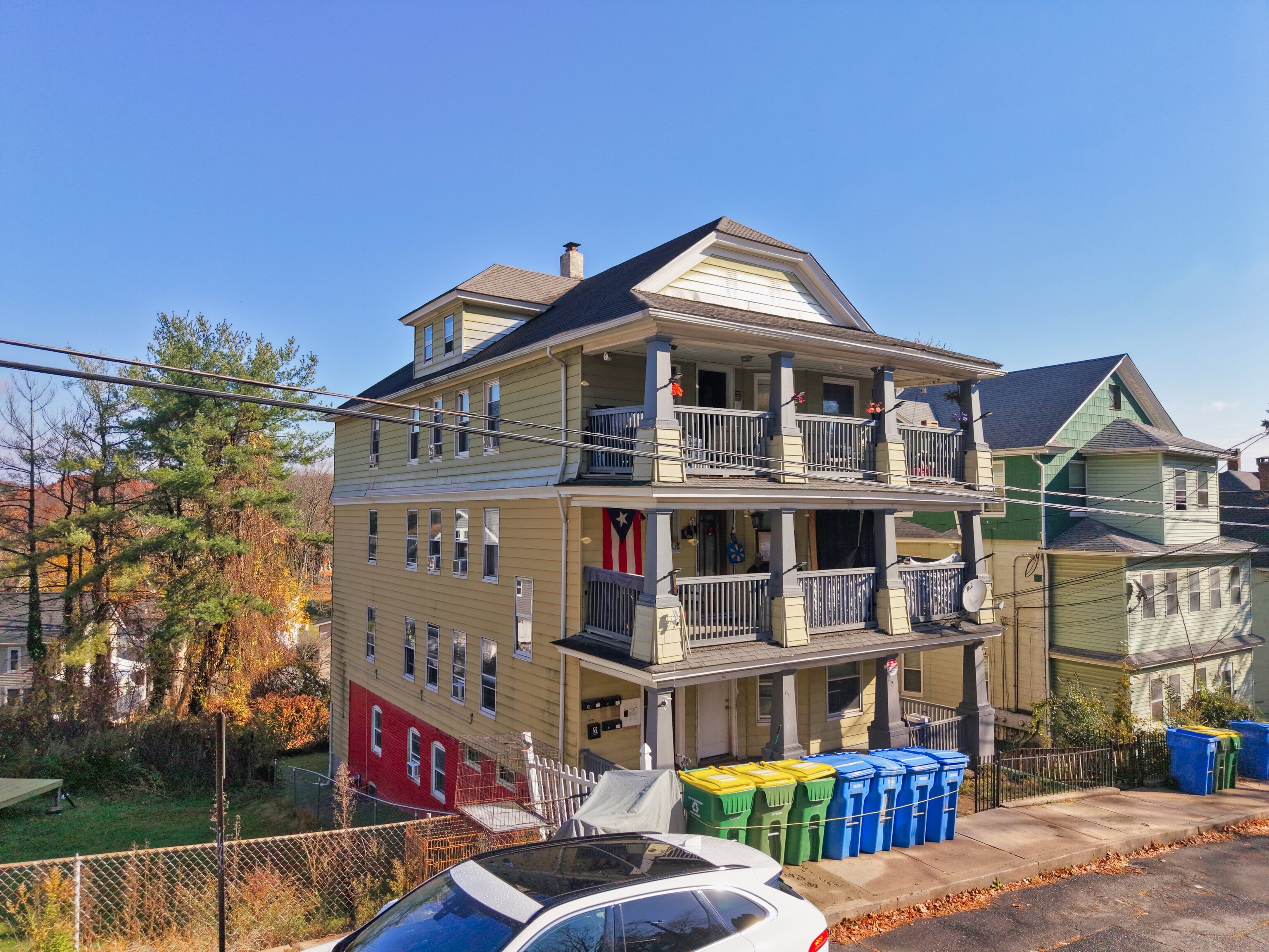 62 Poplar Street Waterbury, CT 06708 - Photo 2 of 23 a front view of a residential apartment building with a yard