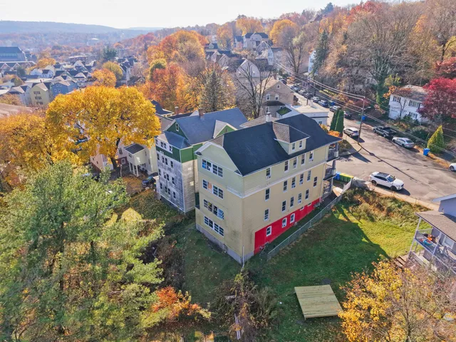 a view of a house with a yard and mountain