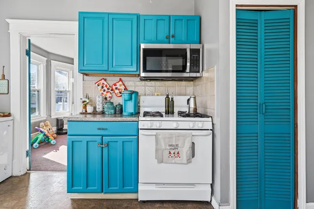 a kitchen with kitchen island a sink and a microwave