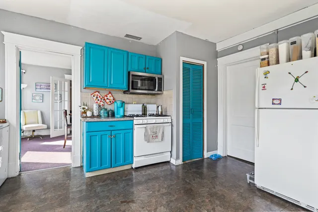 a kitchen with stainless steel appliances a refrigerator sink and microwave