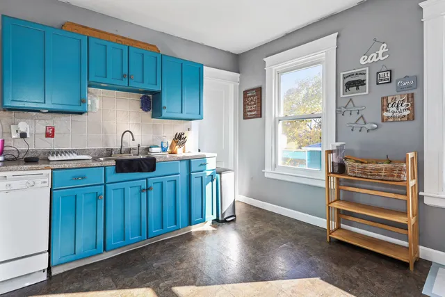 a kitchen with wooden cabinets and a sink