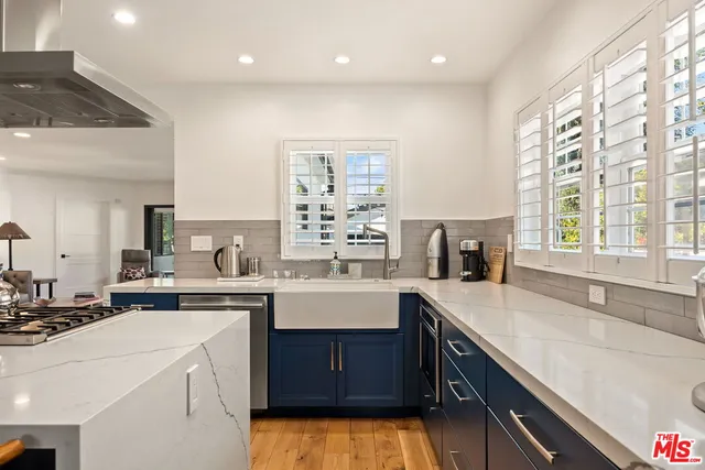 a kitchen with a sink a stove a refrigerator and cabinets