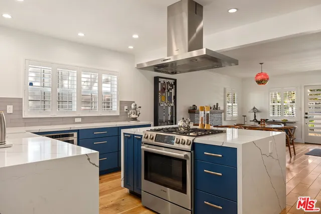 a kitchen with stainless steel appliances granite countertop a stove and a sink