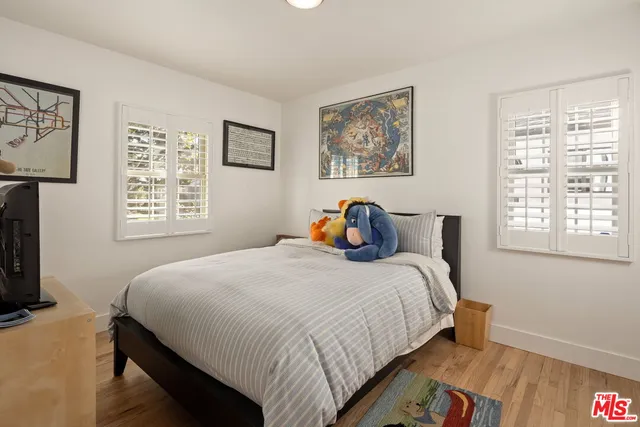 a bedroom with bed and a window