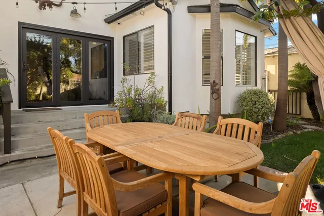 a view of a patio with a table and chairs