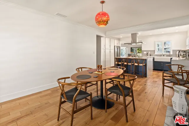 a view of a dining room with furniture and a kitchen