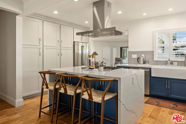 a kitchen with a table chairs sink and cabinets