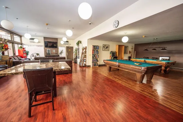 a living room kitchen with furniture and kitchen view