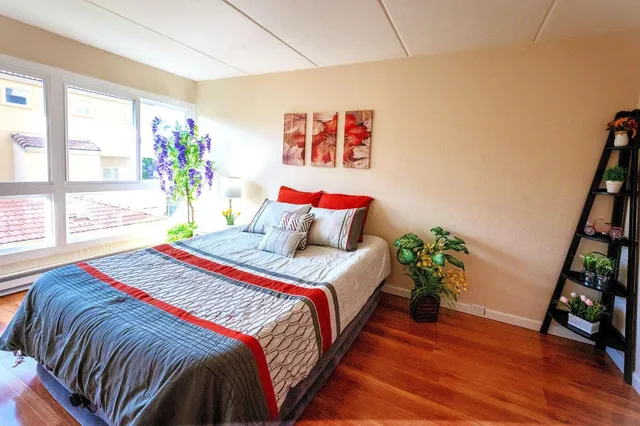 a bed sitting in a bedroom next to a window