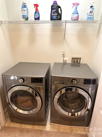 a utility room with a sink washer and dryer