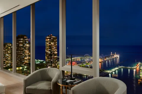 a view of balcony with chairs and potted plants
