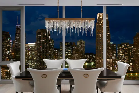 a view of a dining room with furniture and chandelier