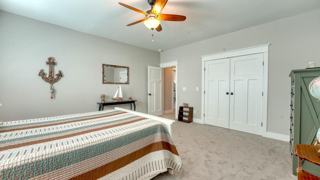 31 Elf School Road Hayesville, NC 28904 - Photo 45 of 59 a bedroom with a bed and a chandelier