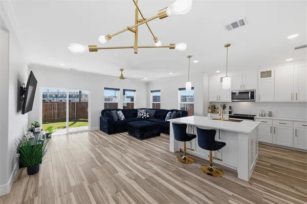 a living room with a couch wooden floor and a table
